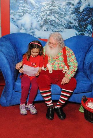 Anna reads her list to Santa