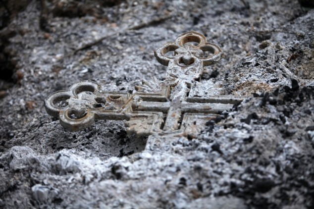 A cross amidst ashes.